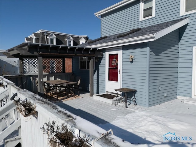 snow covered deck with a pergola