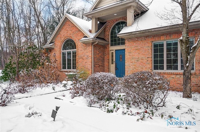 view of snow covered property entrance