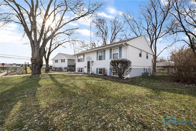 rear view of property featuring a yard