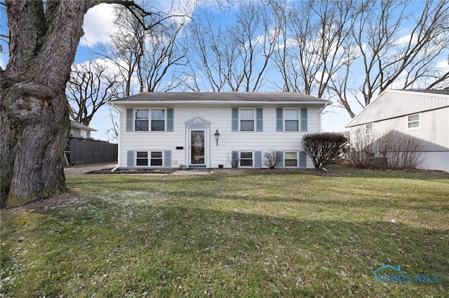 split foyer home with a front lawn