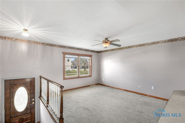 unfurnished room with ceiling fan and carpet floors