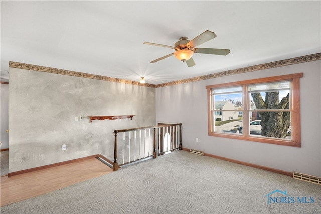 spare room featuring ceiling fan and carpet floors