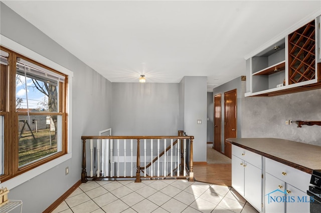 kitchen featuring white cabinetry and light tile patterned floors