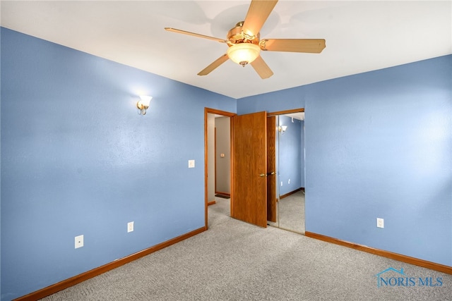 unfurnished bedroom featuring light carpet and ceiling fan