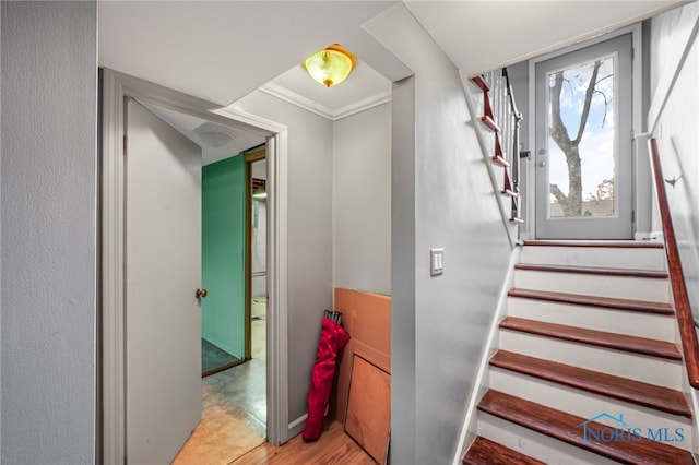 stairway featuring hardwood / wood-style floors and ornamental molding