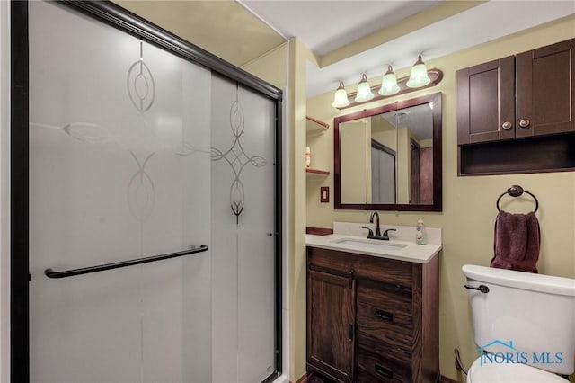 bathroom with vanity, toilet, and walk in shower