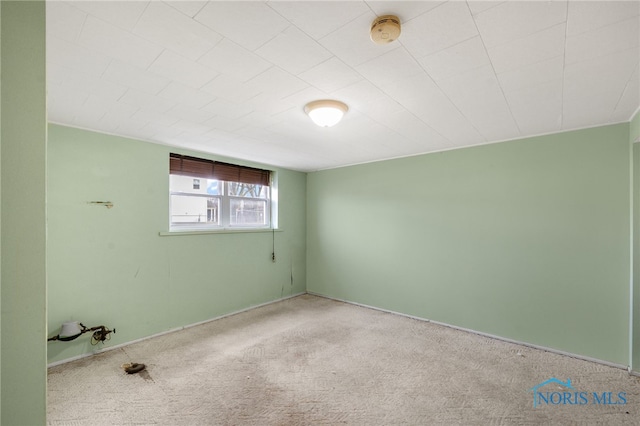 unfurnished room featuring light colored carpet