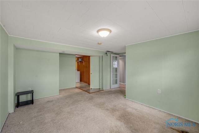 empty room with light carpet and washer / dryer