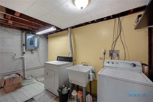 clothes washing area with electric panel and washer and clothes dryer