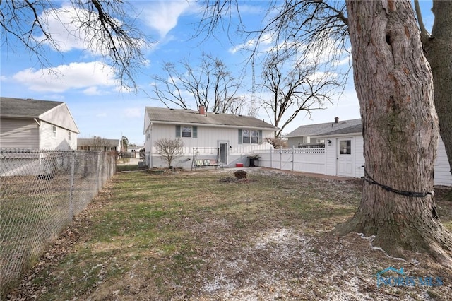 rear view of property with a yard