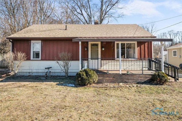 ranch-style home featuring covered porch and a front lawn