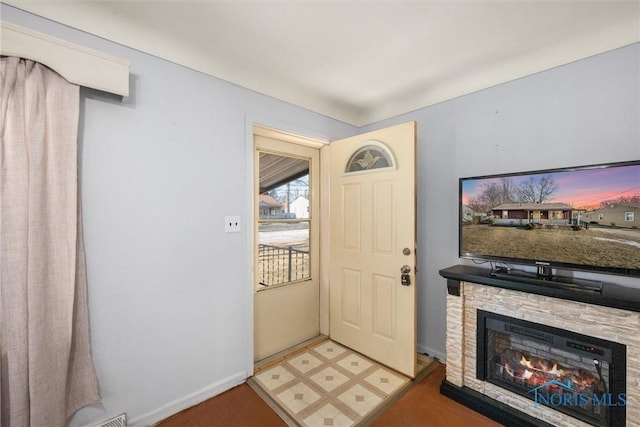 entrance foyer with a stone fireplace