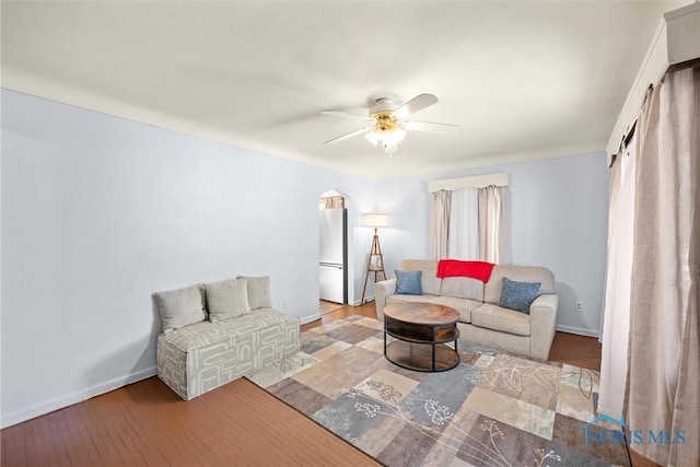 living room featuring ceiling fan and light hardwood / wood-style flooring