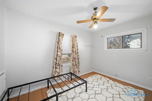 spare room with ceiling fan and wood-type flooring