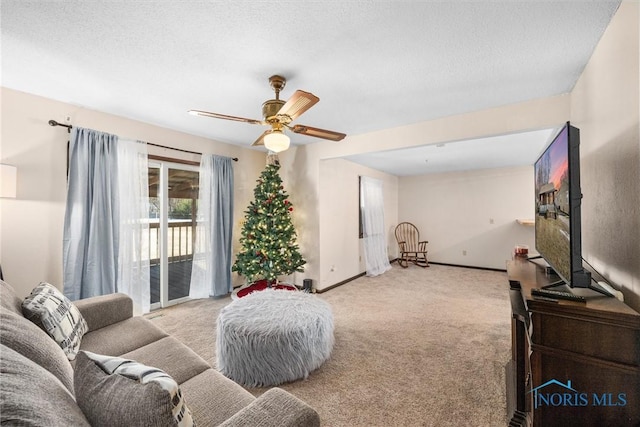 carpeted living room with a textured ceiling and ceiling fan