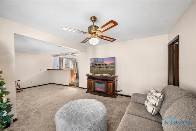 carpeted living room featuring ceiling fan