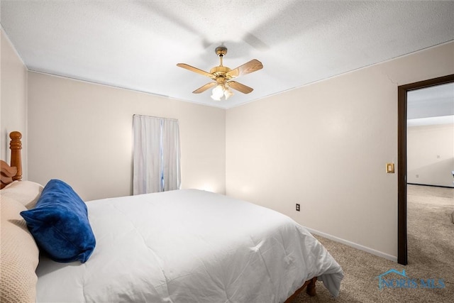 bedroom featuring ceiling fan, a textured ceiling, and carpet floors