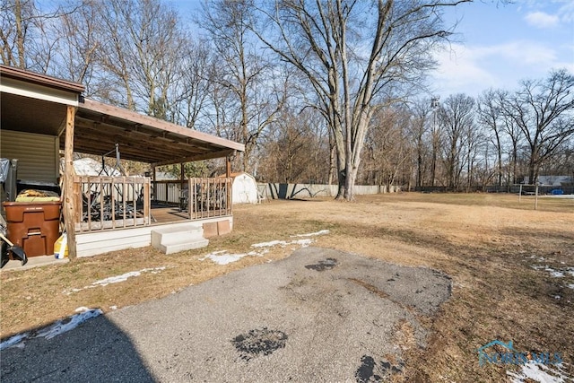 view of yard with a deck and a storage shed