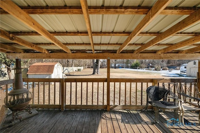 wooden deck featuring a storage shed