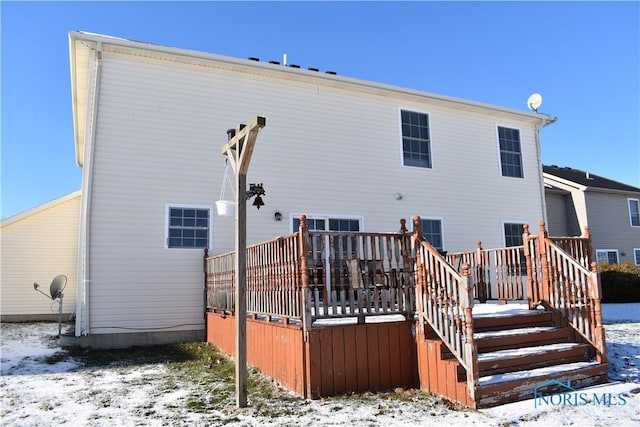 snow covered property featuring a deck