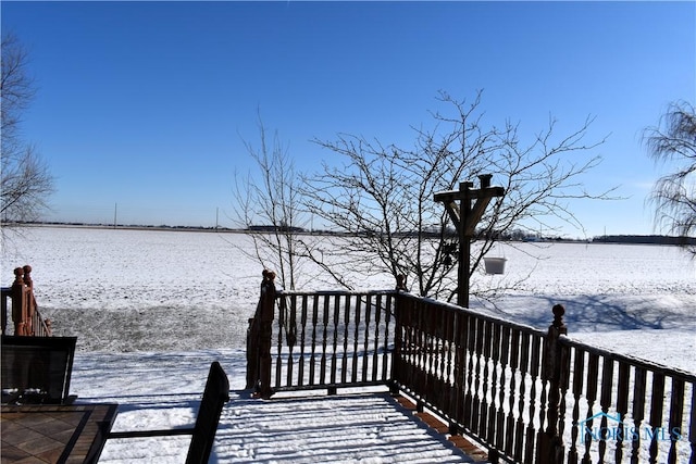 snow covered deck with a water view