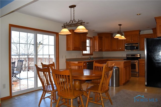 dining space featuring a wealth of natural light and sink