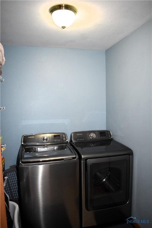 washroom with independent washer and dryer