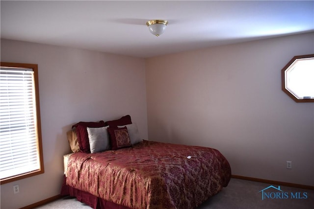 bedroom with multiple windows and light colored carpet