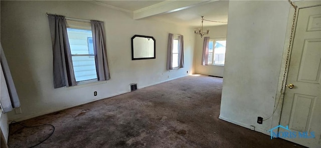 empty room with beamed ceiling, a notable chandelier, and carpet floors