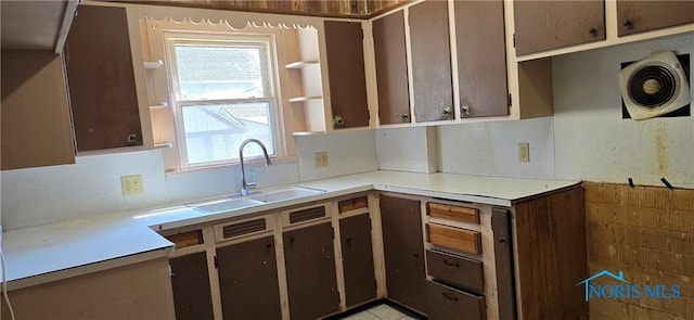 kitchen with dark brown cabinets, plenty of natural light, and sink