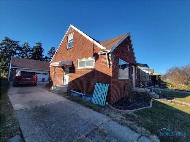 view of property exterior featuring a garage and an outbuilding