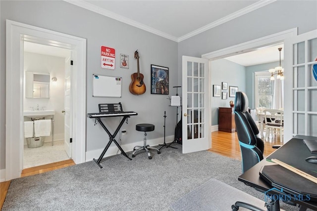 home office featuring carpet, french doors, crown molding, sink, and a notable chandelier