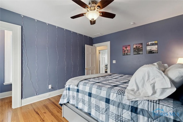 bedroom featuring ceiling fan and hardwood / wood-style flooring