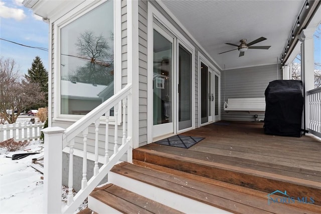 snow covered deck featuring grilling area and ceiling fan