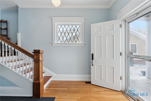 entrance foyer with ornamental molding and light wood-type flooring