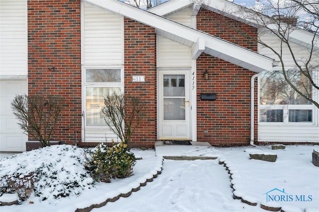 view of snow covered property entrance