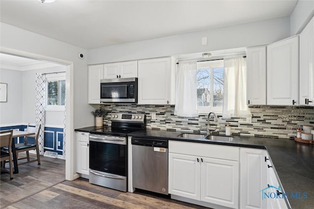 kitchen with white cabinetry, sink, and appliances with stainless steel finishes