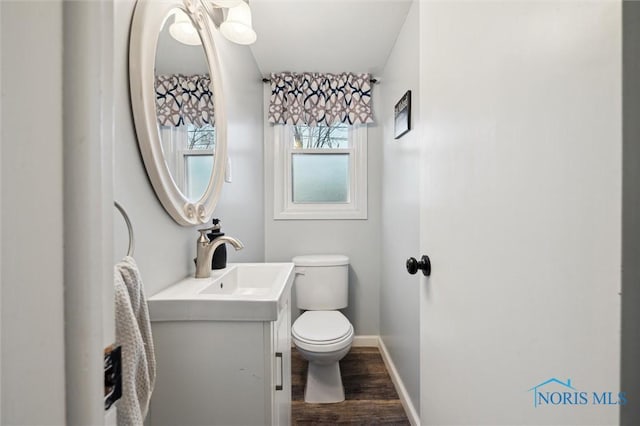 bathroom with hardwood / wood-style floors, vanity, and toilet