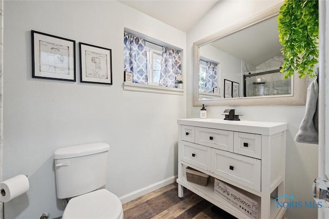 bathroom featuring an enclosed shower, vanity, vaulted ceiling, wood-type flooring, and toilet