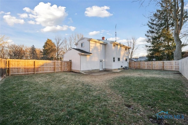 rear view of house featuring a yard