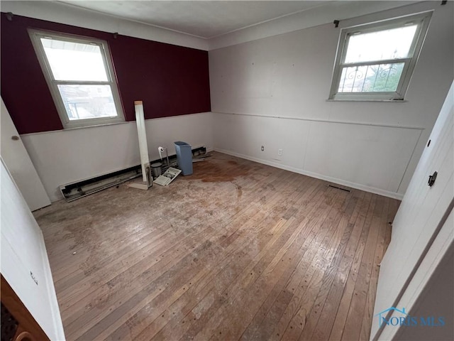 unfurnished room with hardwood / wood-style floors