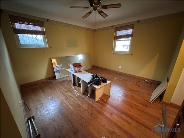 interior space with wood-type flooring and ceiling fan