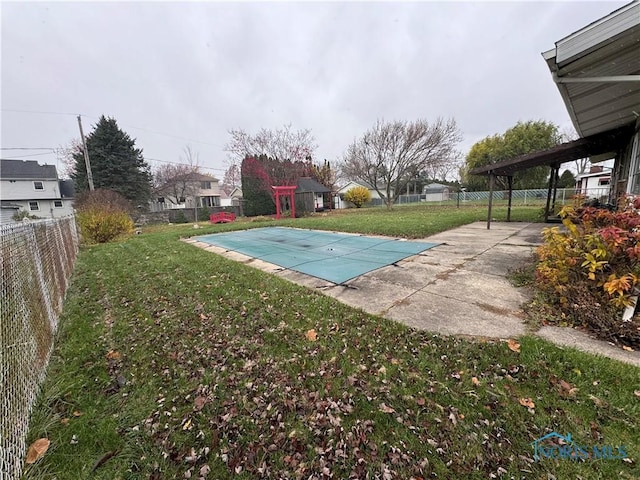 view of pool featuring a yard and a patio