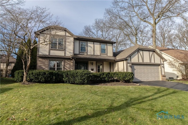 view of front of house with a garage and a front lawn