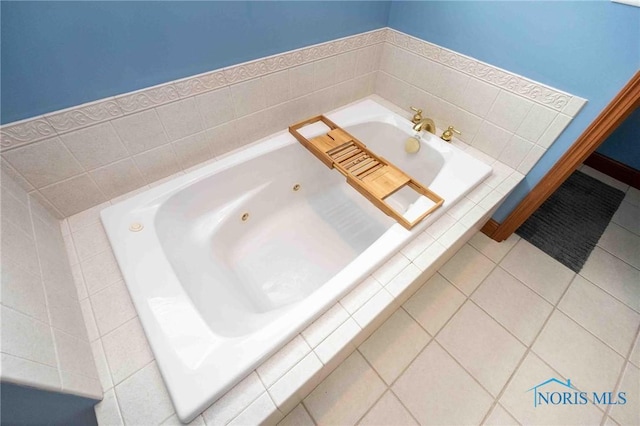 bathroom with tile patterned flooring and a relaxing tiled tub