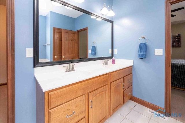 bathroom featuring tile patterned flooring, vanity, and a chandelier