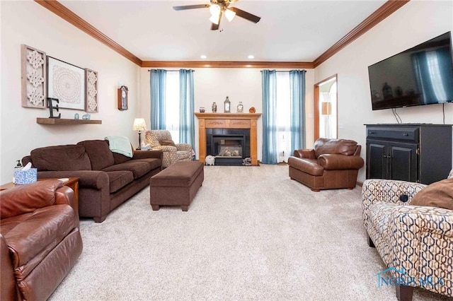 living room featuring ceiling fan, carpet, and ornamental molding