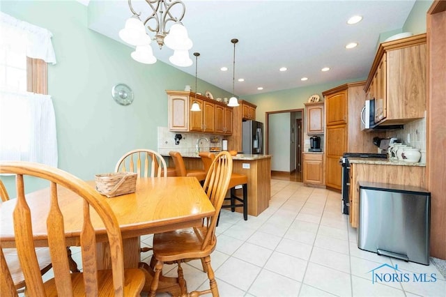 dining room with a notable chandelier, light tile patterned floors, and sink