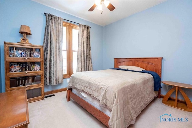 bedroom with light carpet and ceiling fan