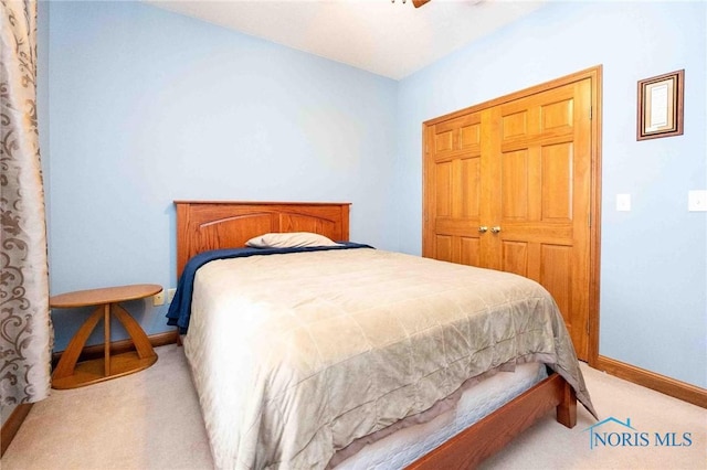 carpeted bedroom featuring a closet